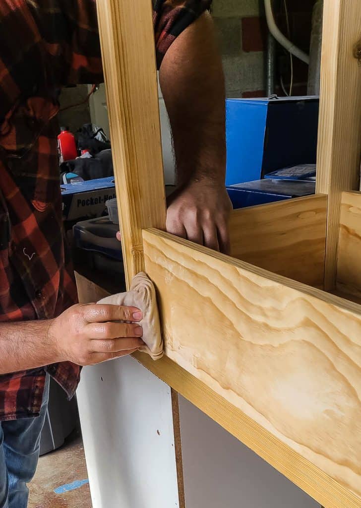 putting on a linseed oil finish to wooden structure for diy dress up storage rack for a natural look