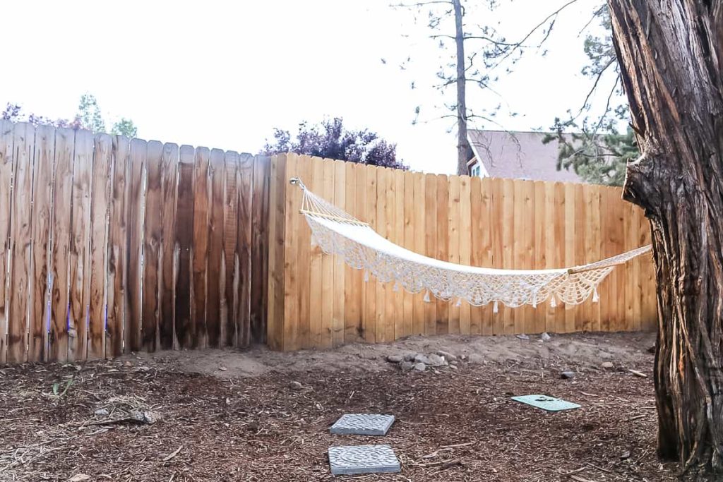 shows a wooden fence with a hammock