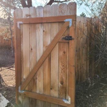 Open wooden gate in the backyard