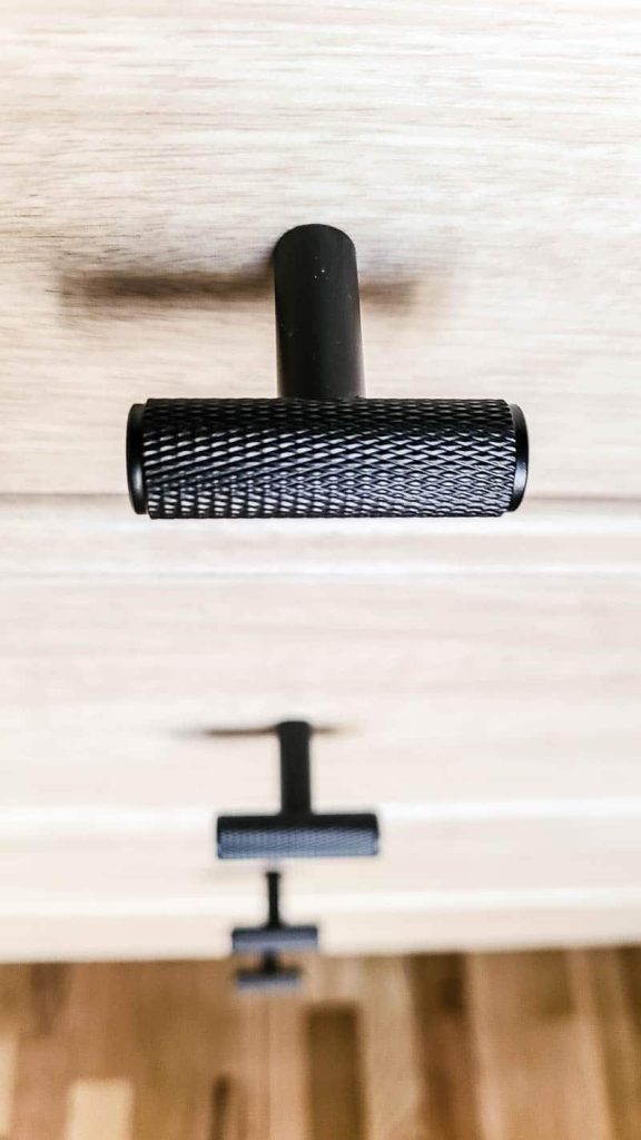 black drawer hardware on drawers in closet