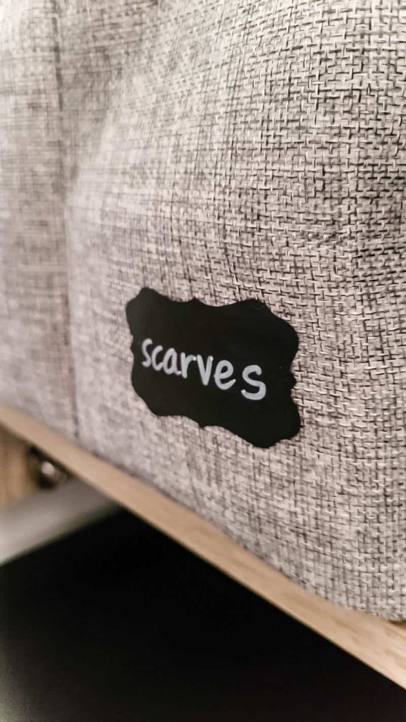 chalkbaord sticker label on fabric bin in closet that says scarves