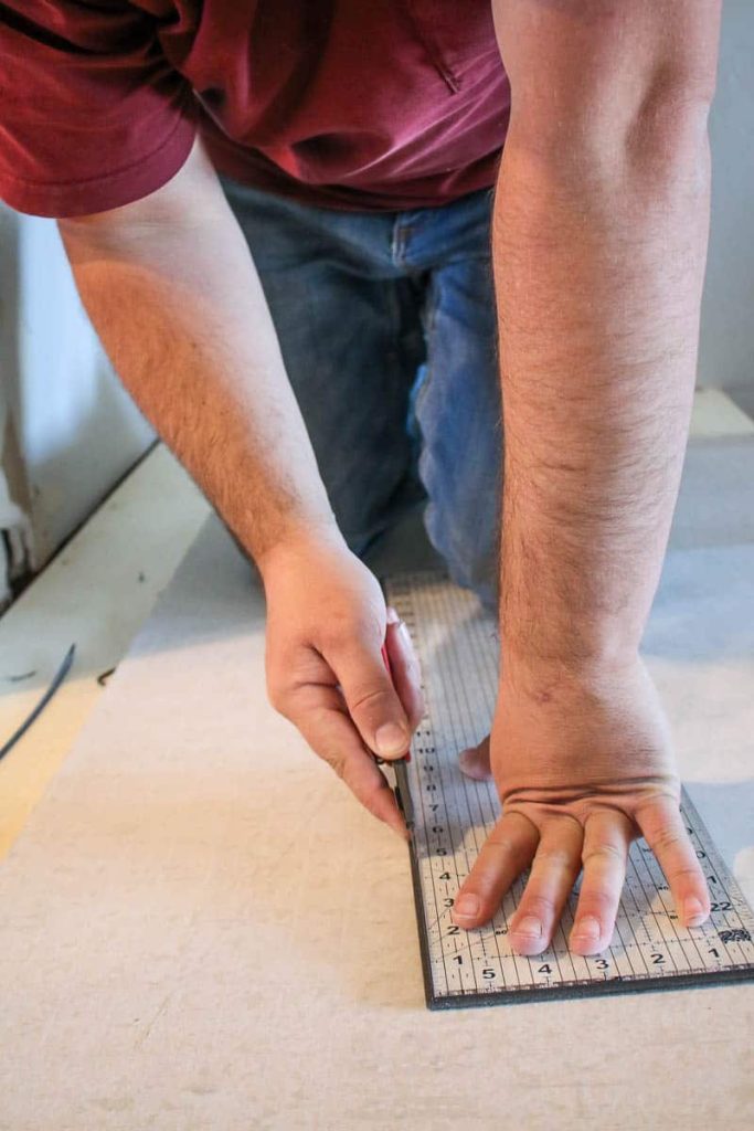 Trimming wall panels with a utility knife