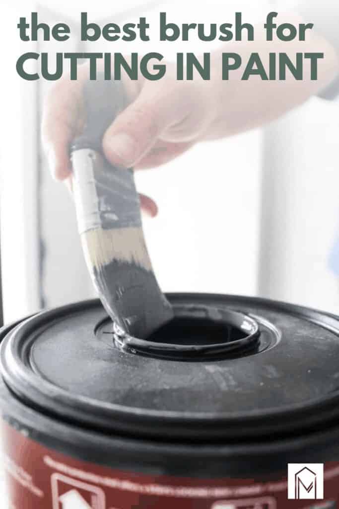 Man holding a paint brush dipped in a bucket of gray paint with text overlay that says the best brush for cutting in paint