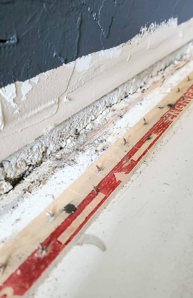 carpet tack strip along perimeter of wall