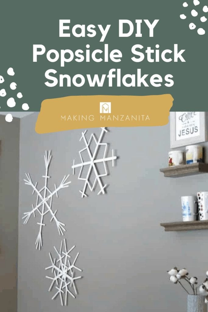 Popsicle stick snowflakes hanging on the wall in the winter designed dining area with text overlay that says Easy DIY popsicle stick snowflakes