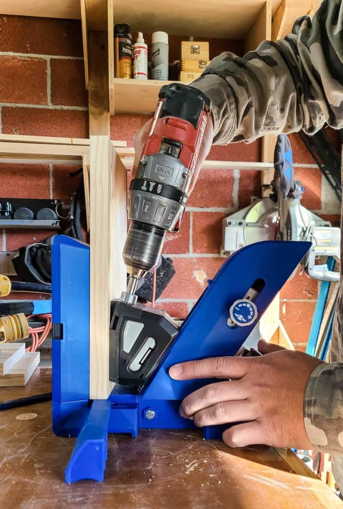Man drilling a wood using the pocket hole jig from Kreg Tools