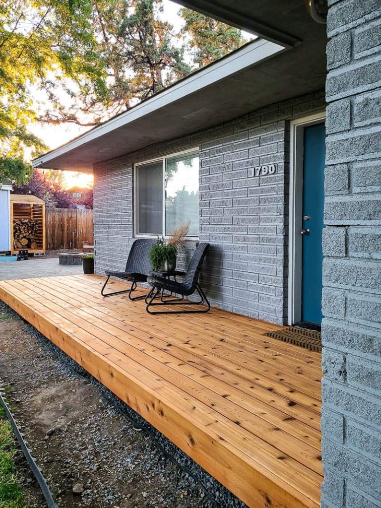 Small wooden deck on the side of house protected with decking oil for a beautiful natural looking finish.