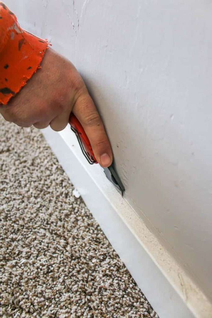 in Removing baseboards use a utility knife to cut caulk between a baseboard and wall