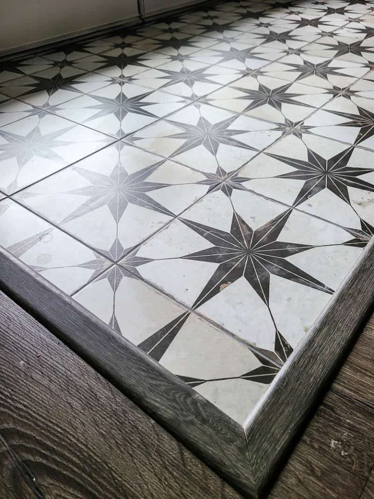 Small entryway with newly installed floor tiles with boho star pattern