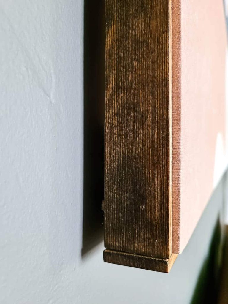 Close up of the wooden tapestry frame hanging on the wall 