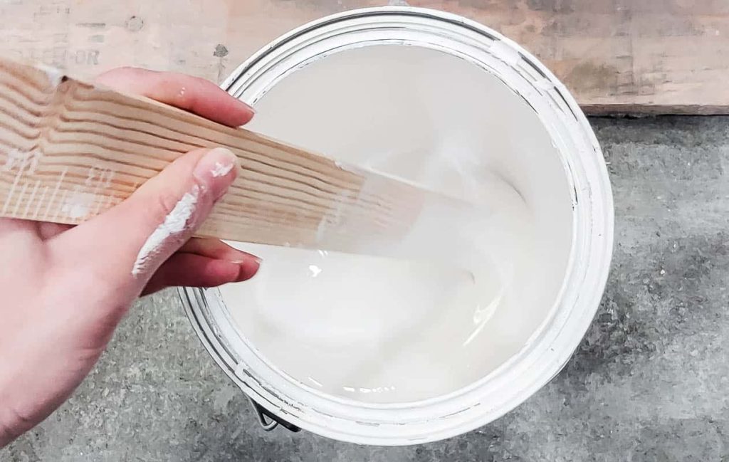 Mixing the white paint with wood