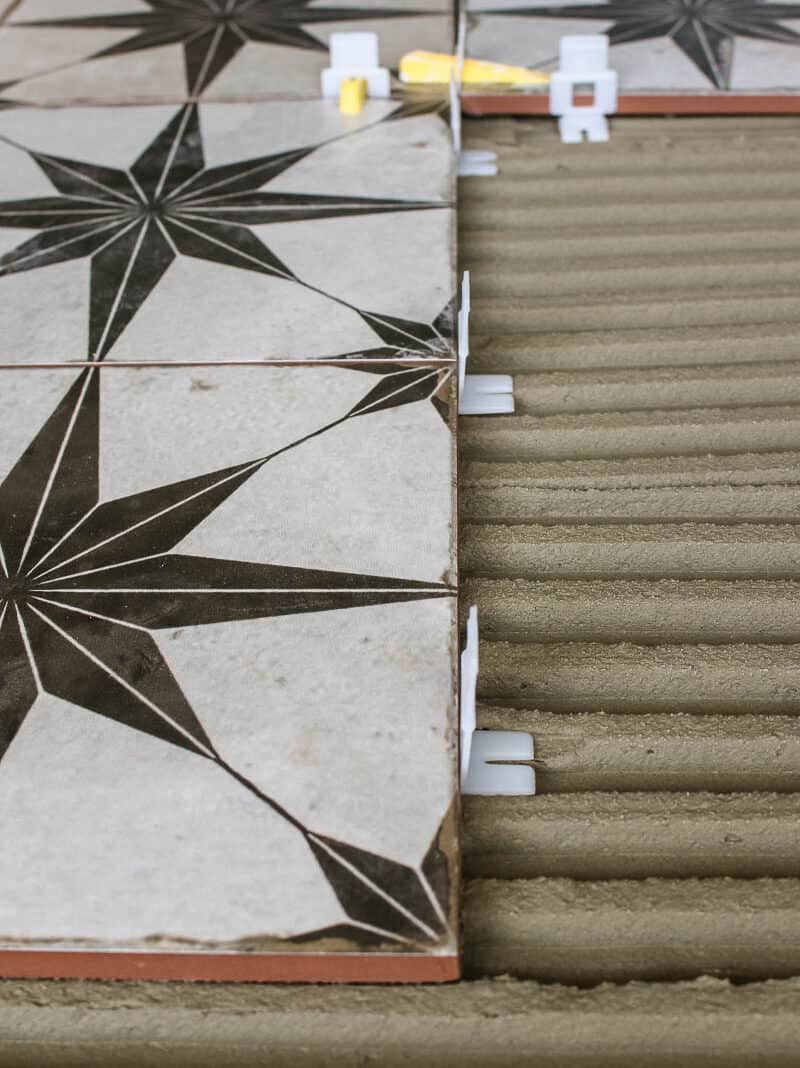 These clip and wedge spacers not only give you the right spacing between your tiles, which you'll grout later - but they also help keep the tiles level with each other. 
