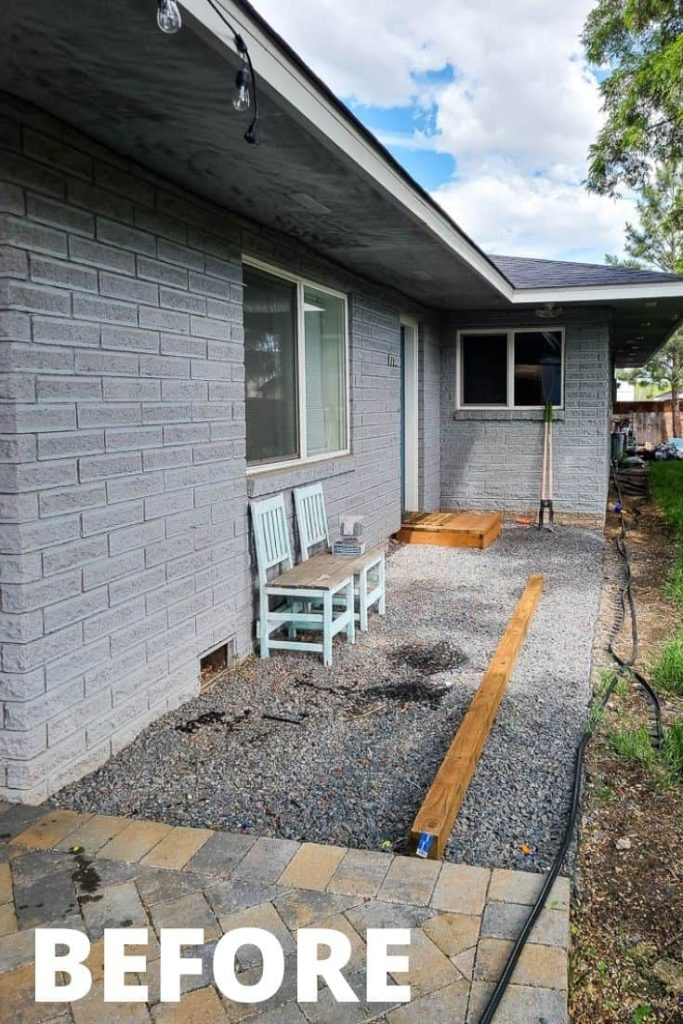 View of the backyard showing the landscape fabric and gravel in the area with two wooden chairs before the makeover