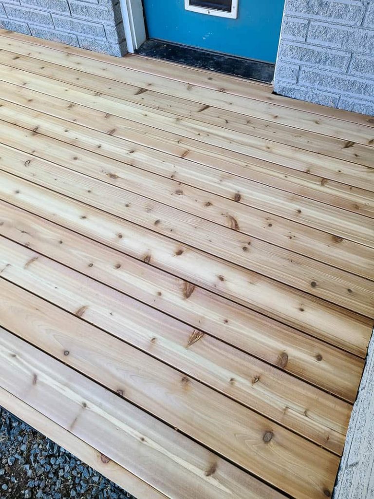 Close up of the backyard with wood deck board attached
