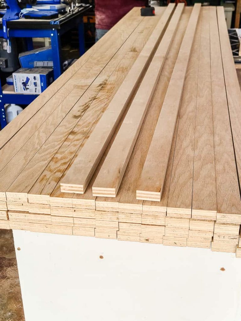 slats of wood on the table before being installed on the wall