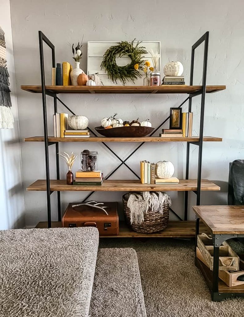 You can use items like pumpkins and fall colors to switch the decorations up on the shelving unit for the seasons. 