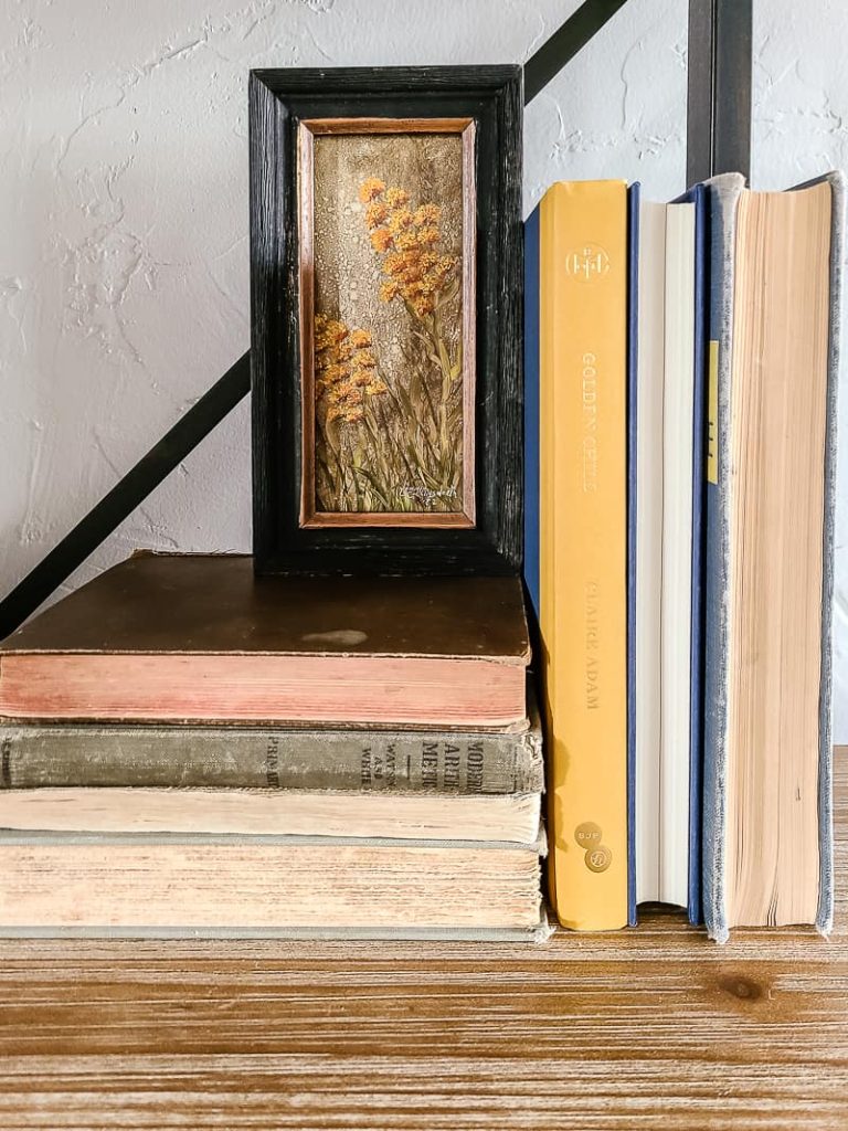 art and books displayed on shelf