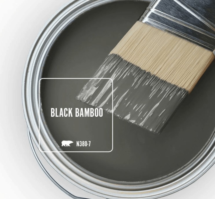Behr black bamboo paint color in can and a paint brush dipped in it
