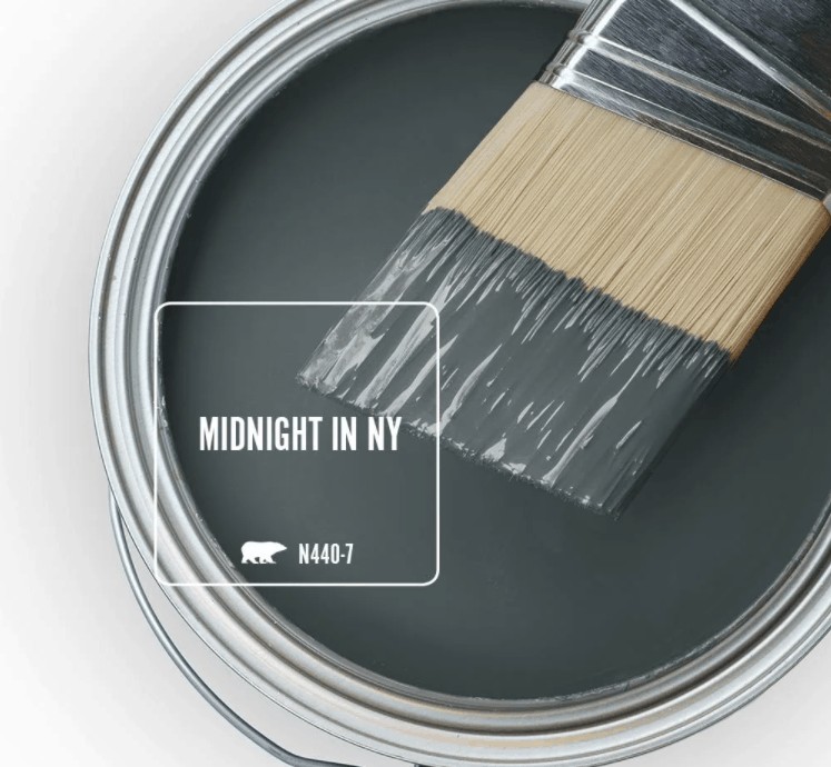 Behr midnight in NY paint color in can and a paint brush dipped in it