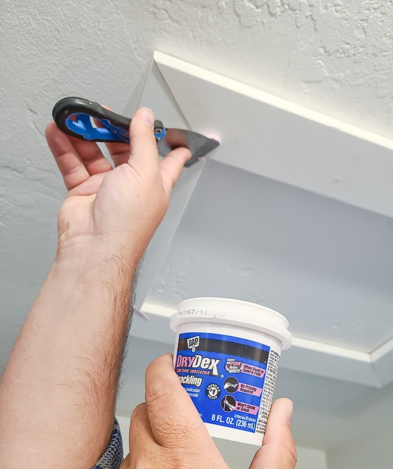 We used DAP's DryDex spackle applied smoothly with a putty knife. I love that this spackling starts pink and turns white when it is dry. 