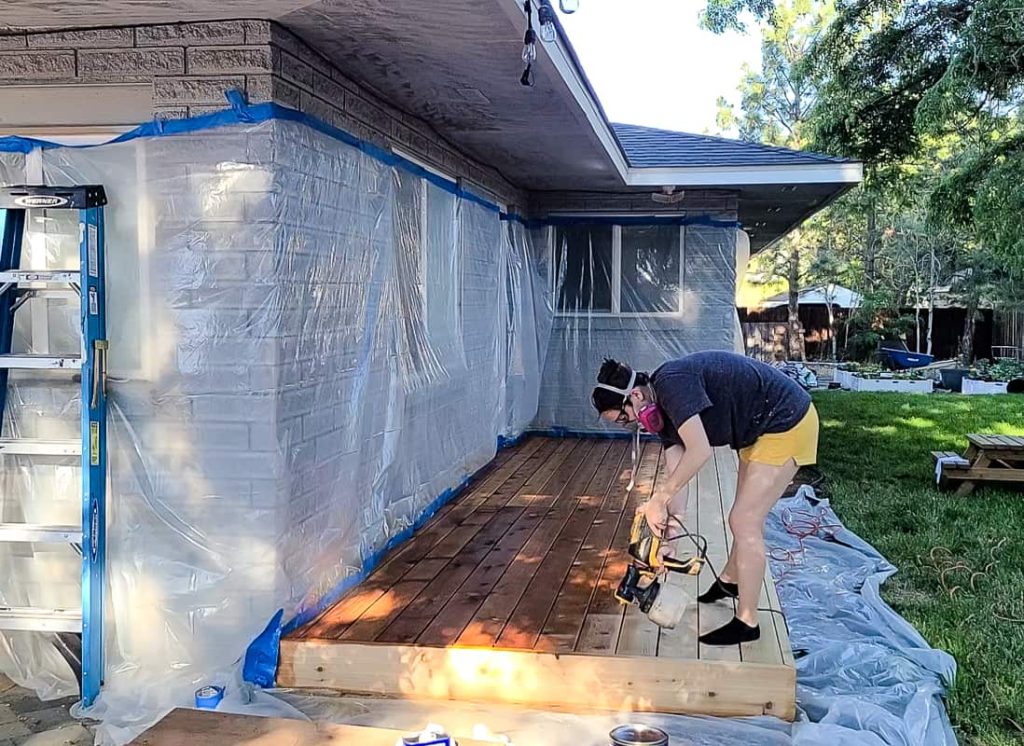 Woman spraying oil on the deck