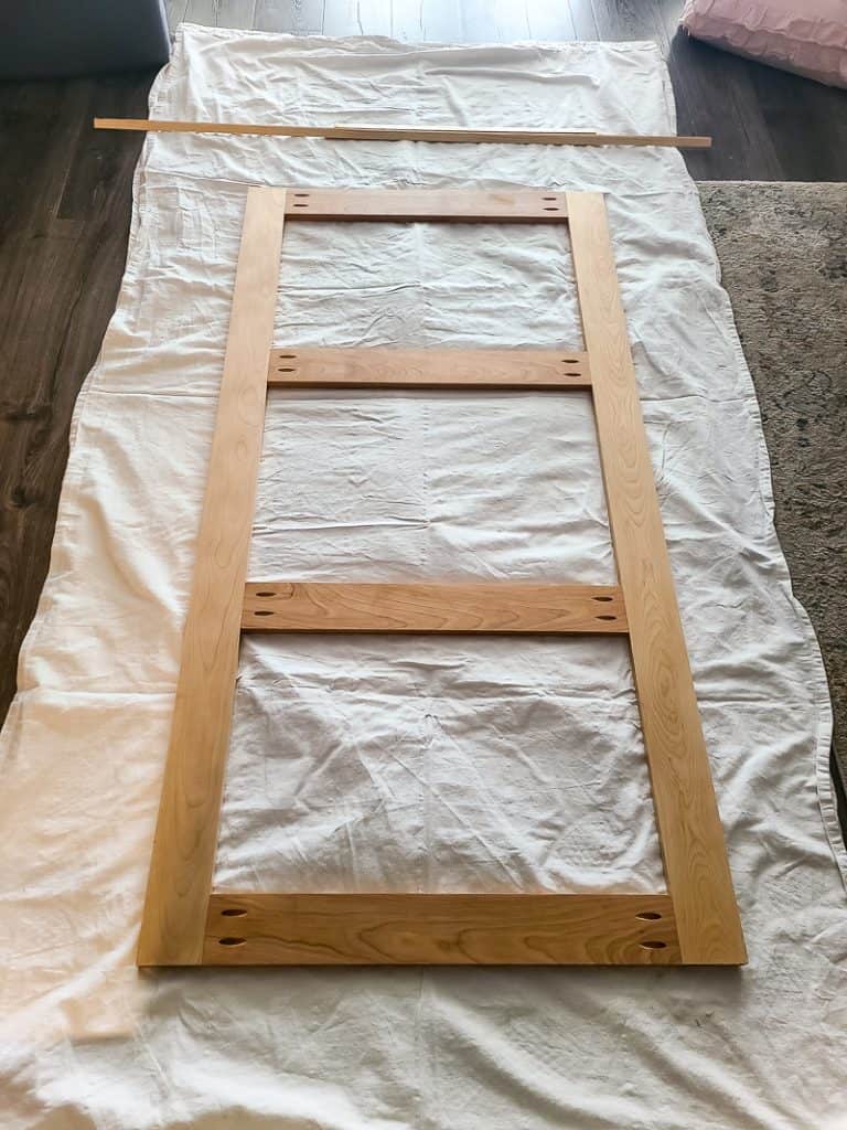 Photo of a headboard being stain for natural finish.