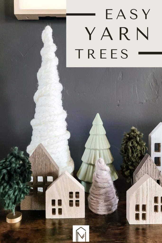 Boho DIY yarn Christmas trees with mini wooden houses display with text overlay that says easy yarn trees 