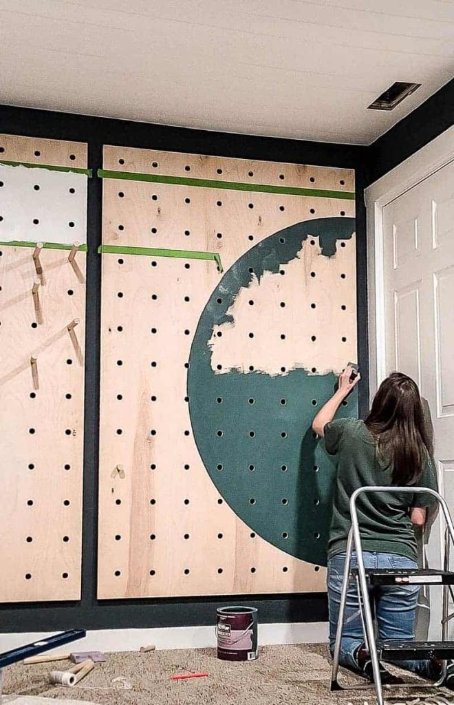 office pegboard made with plywood being painted with shapes 