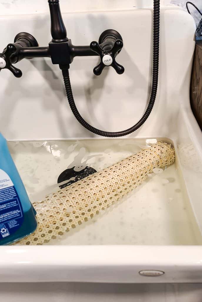 Preparing the cane involves soaking it in water to make it pliable and easier to attach to the headboard.