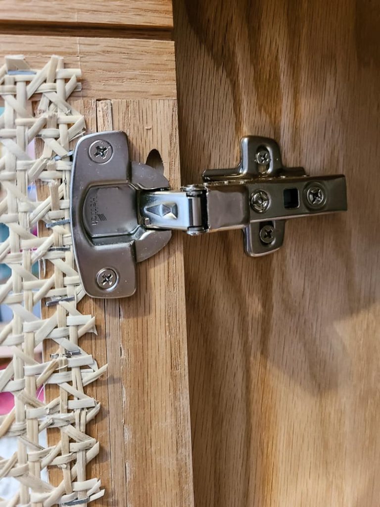 Nightstand door securely onto its hinges.