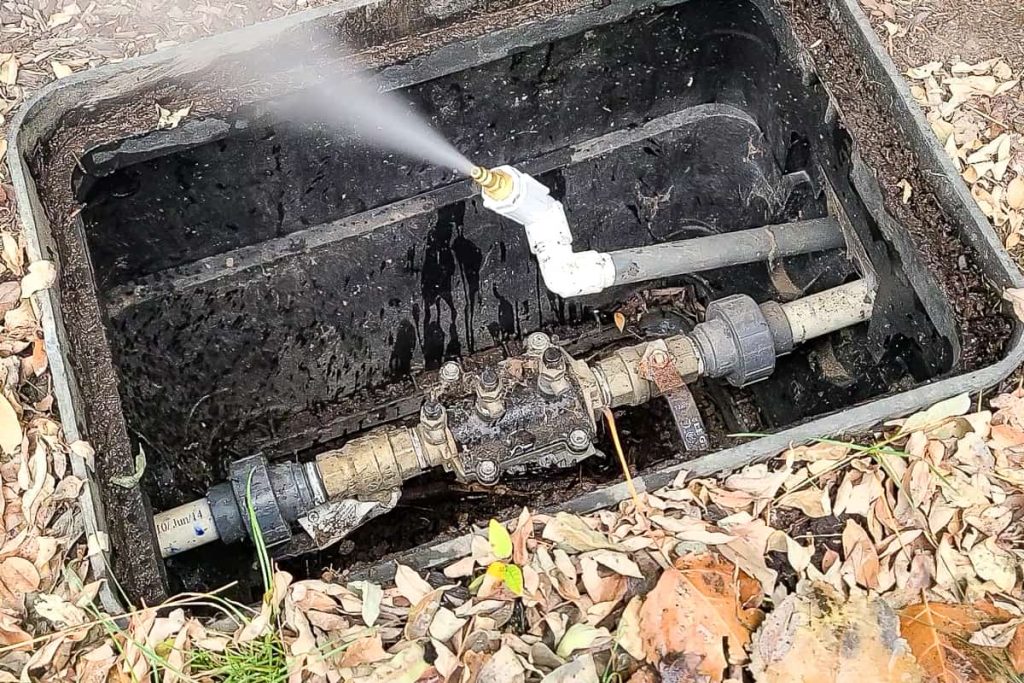 Water supply valve with adapter after compressor hose has been removed blowing air out of the water line.