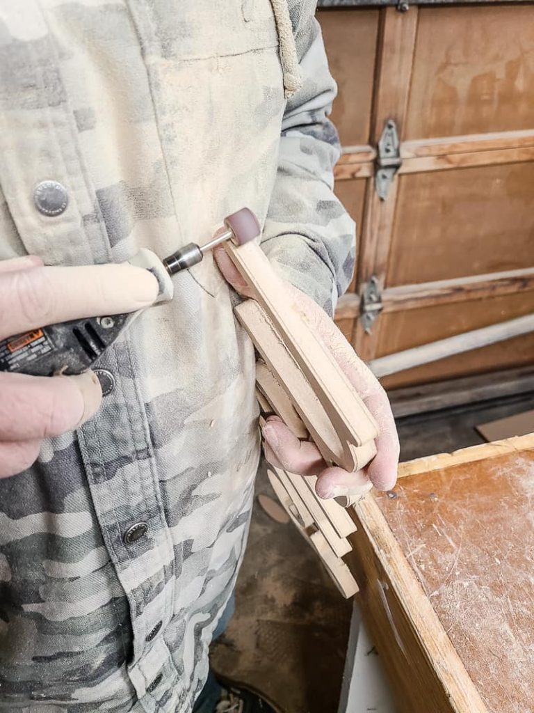 We used our Dremel tool and cutting bit to slice through the tabs that the X-Carve leaves behind. Then carefully smooth out the edges of the wooden letters with a Dremel and sanding bit where the tabs were. 
