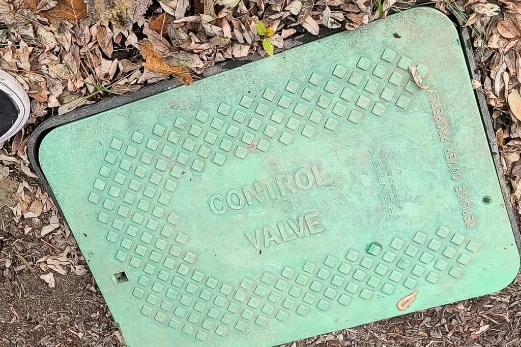 Look for this green sprinkler control valve cover on ground to start your sprinkler blowout process
