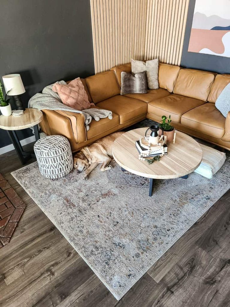 https://www.makingmanzanita.com/wp-content/uploads/2021/12/vintage-inspired-area-rug-under-corner-sectional-with-hard-laminate-flooring-768x1024.jpg