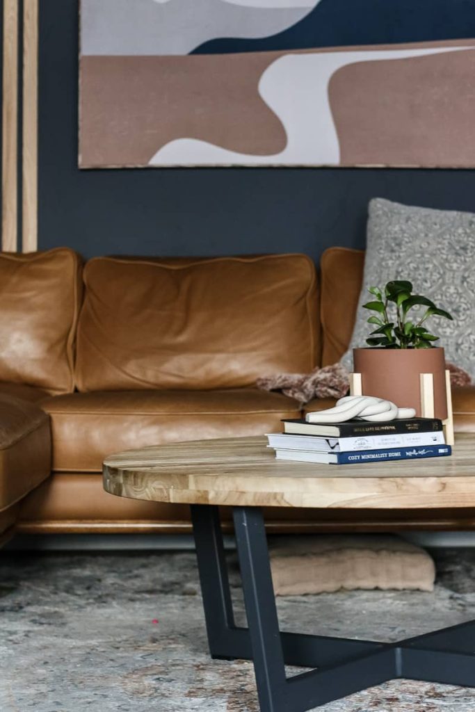 Our polymer clay knot fits right in our modern boho living room area with coffee table and leather sectional couch