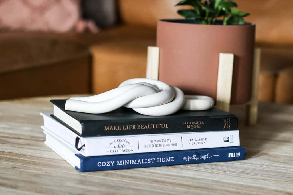 decorative clay knot on stack of coffee table books