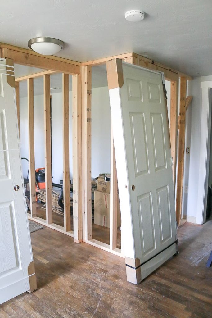 Image of framing for a wall with a door leaning against it.
