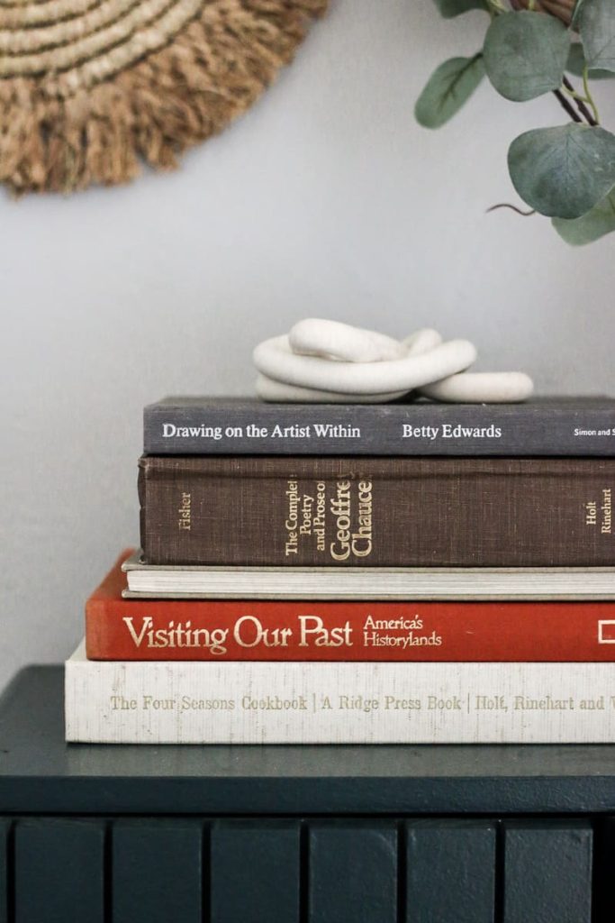 If you're stumped on how to decorate on top of a cabinet or shelf, try a stack of books with polymer clay knot on top. 