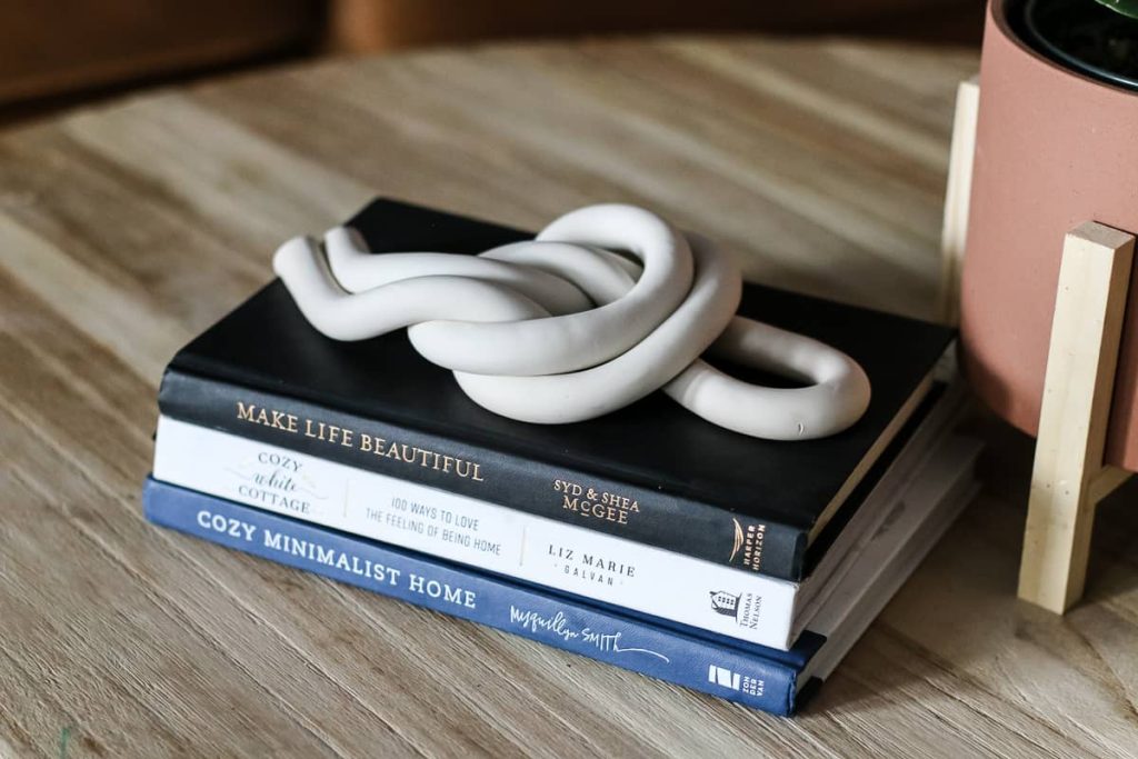 I love this do-it-yourself clay knot resting on coffee table books with planter in our living room.