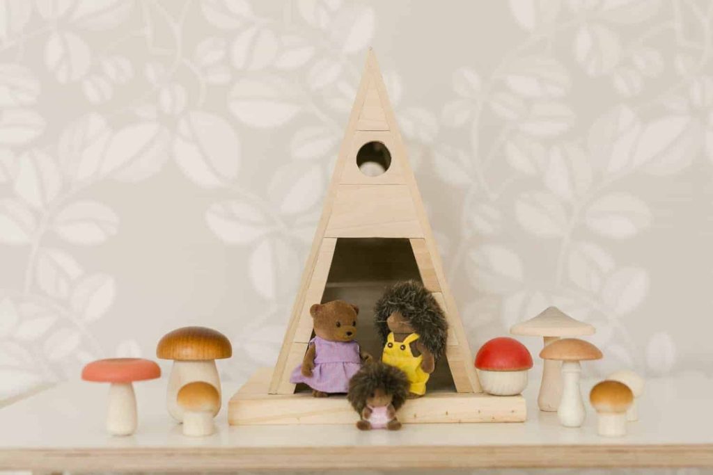 small dollhouse in A-frame shape with small animal characters