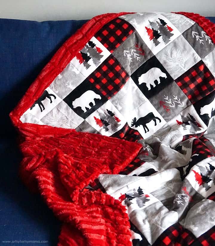 Red, white and black quilt with woodland animals