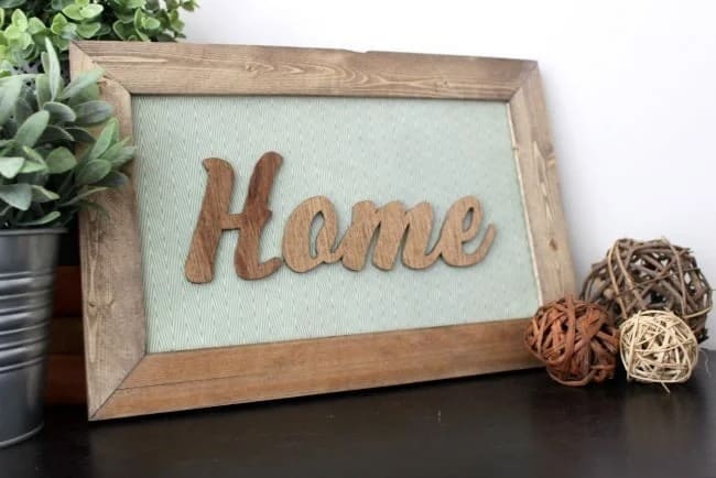 wooden word "home" in a rustic frame