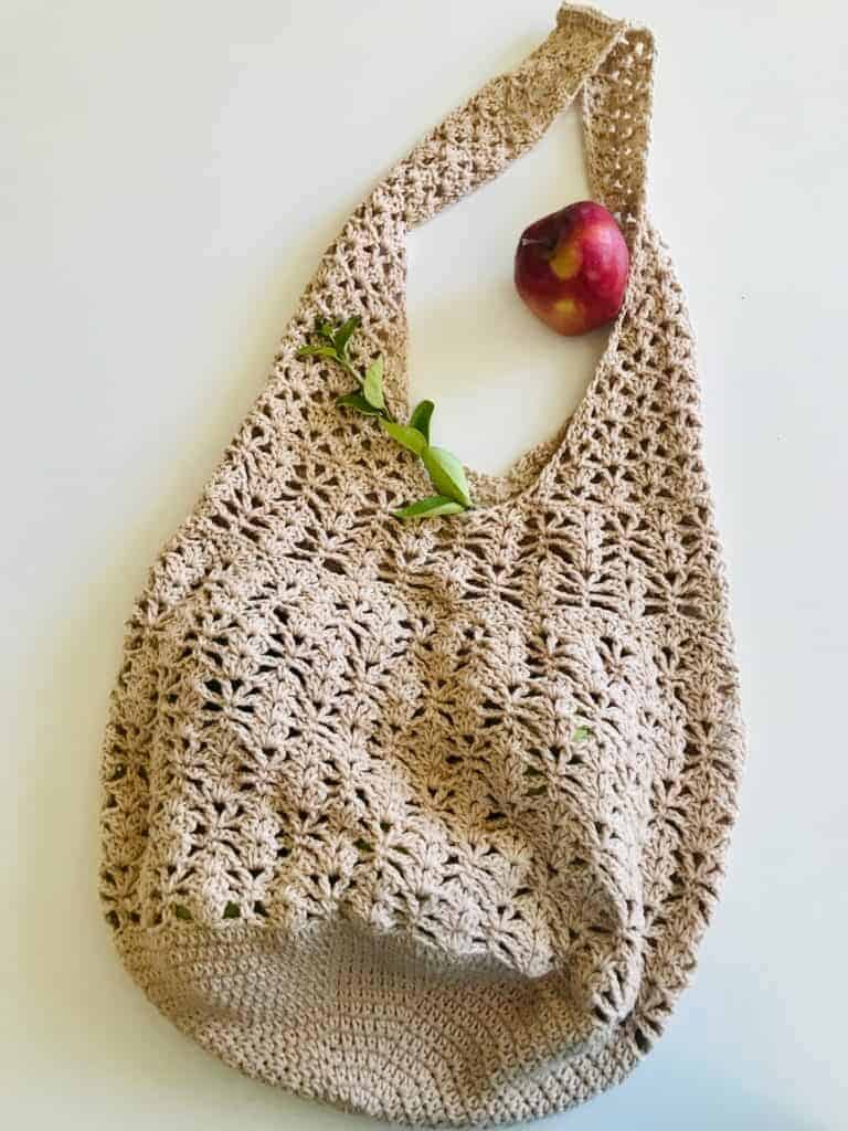 crochet bag with apple laying next to handle