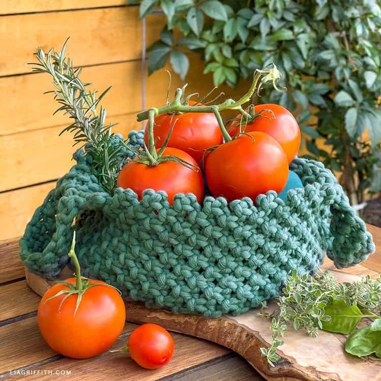 macrame basket holding tomatoes