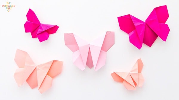 Five pink origami butterflies