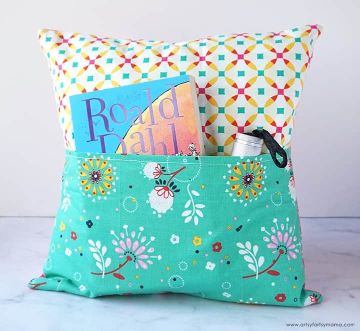 Colorful fabric pillow with a pocket to hold a book