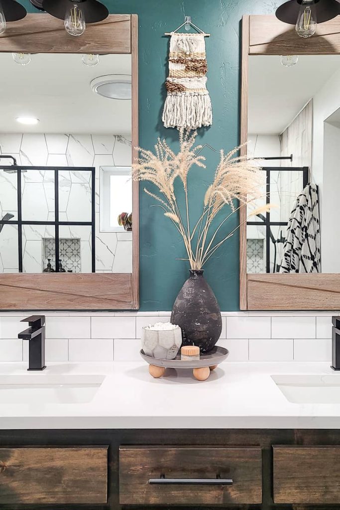 DIY footed tray on bathroom vanity counter with pottery vase and wheat stalks, small bowl of Q-tips and small canister of face lotion