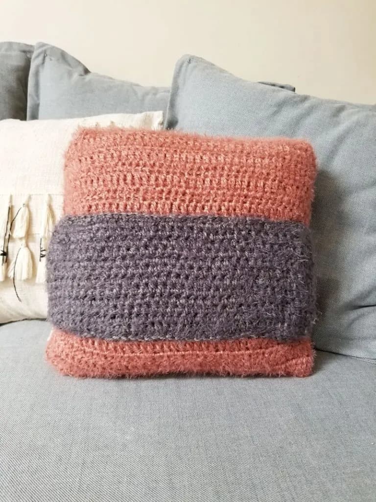 pink crochet pillow with purple pocket