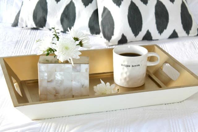 soap dispenser turned into a vase sitting on a tray with coffee mug