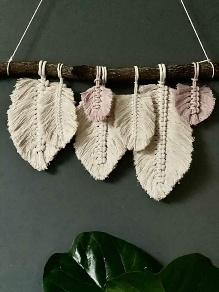 macrame feather wall hanging with natural and pink colored feathers